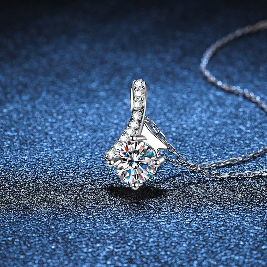 Ribbon Round Moissanite Pendant Necklace in Platinum-Plated S925 Sterling Silver blue background close-up view