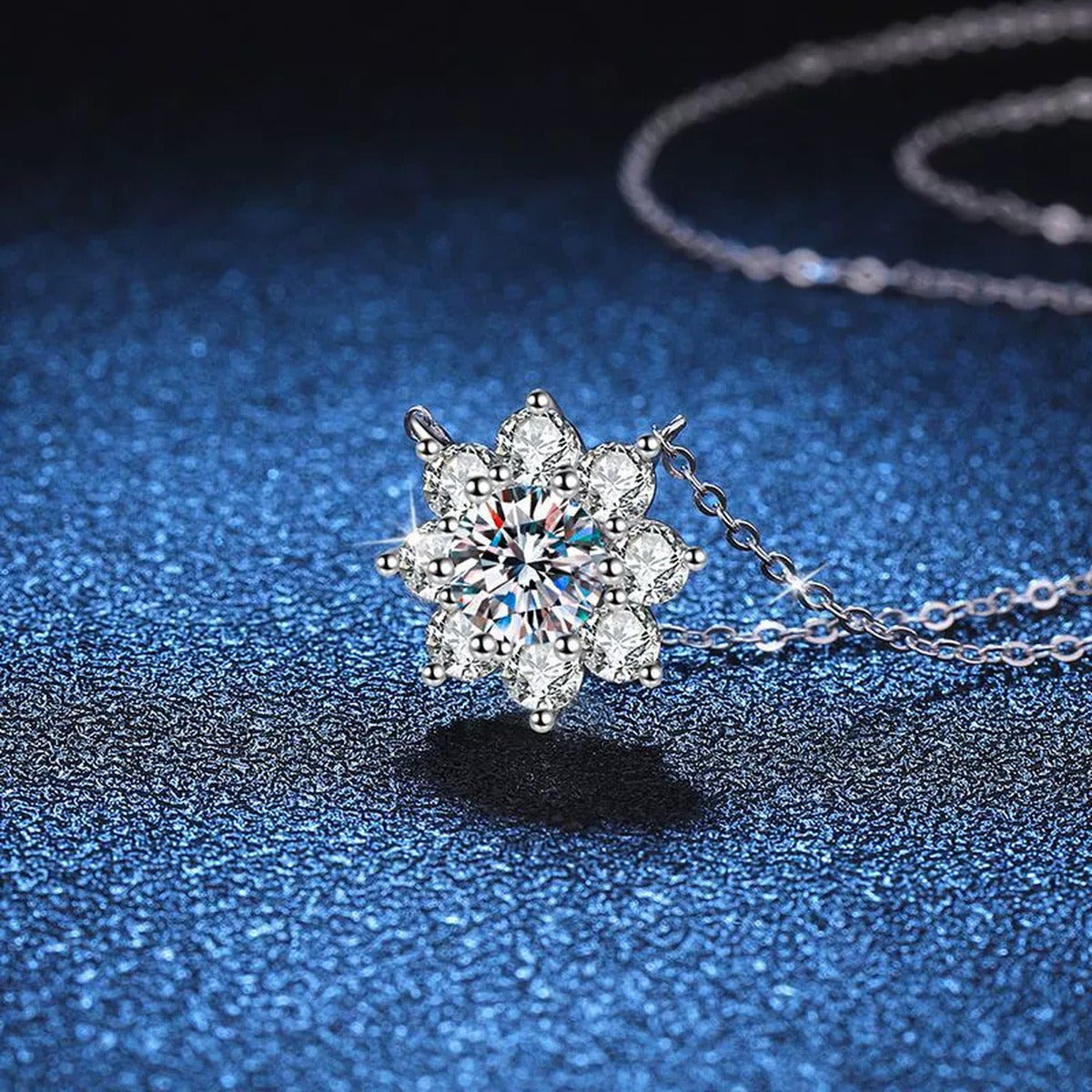 Starburst Moissanite Pendant Necklace in Platinum-Plated S925 Sterling Silver blue background angled detail view