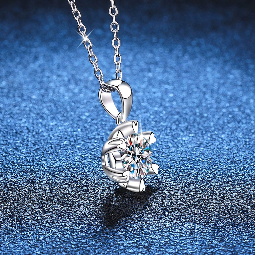 Sunburst Round Moissanite Pendant Necklace in Platinum-Plated S925 Sterling Silver blue background angled detail view
