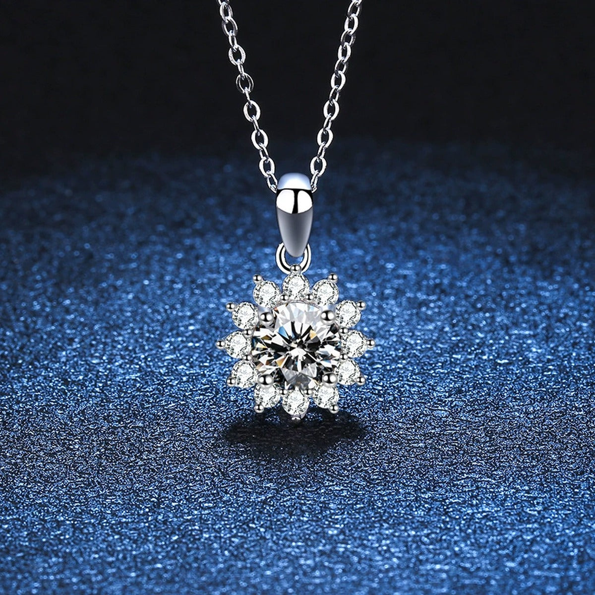 Floral Halo Moissanite Pendant Necklace in Platinum-Plated S925 Sterling Silver blue background angled detail view