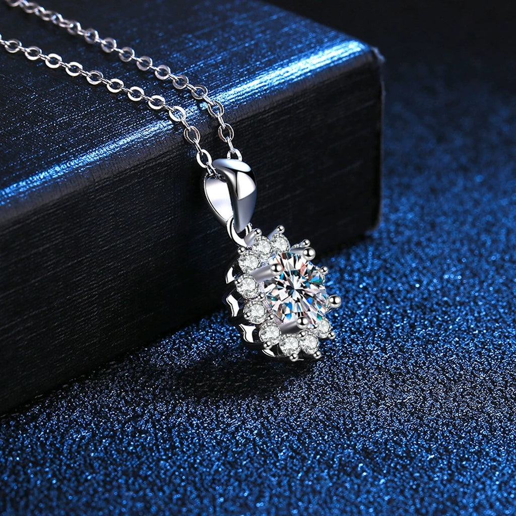 Floral Halo Moissanite Pendant Necklace in Platinum-Plated S925 Sterling Silver blue background close-up view