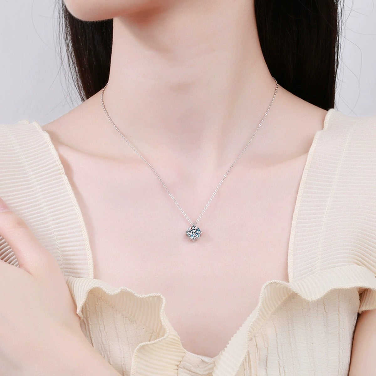 Graduated Moissanite Station Necklace in Platinum-Plated S925 Sterling Silver worn by model at neckline