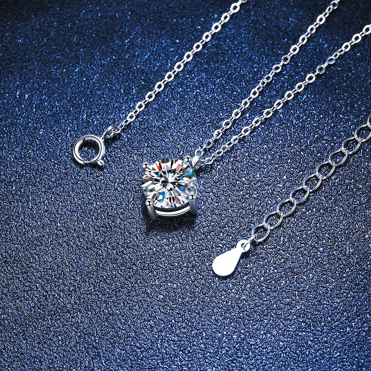 Graduated Moissanite Station Necklace in Platinum-Plated S925 Sterling Silver blue background angled detail view