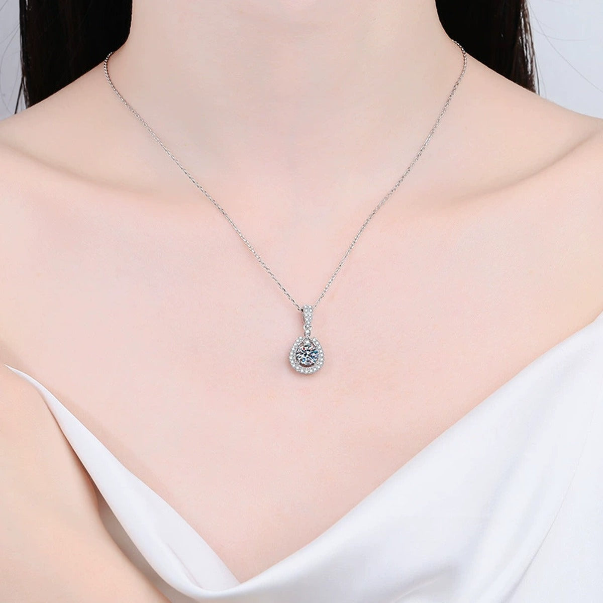 Pear Halo Moissanite Drop Necklace in Platinum-Plated S925 Sterling Silver worn by model at neckline