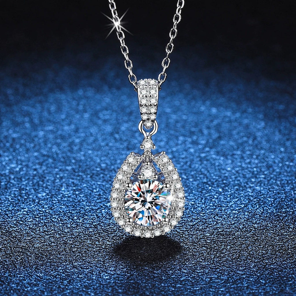 Pear Halo Moissanite Drop Necklace in Platinum-Plated S925 Sterling Silver blue background angled detail view