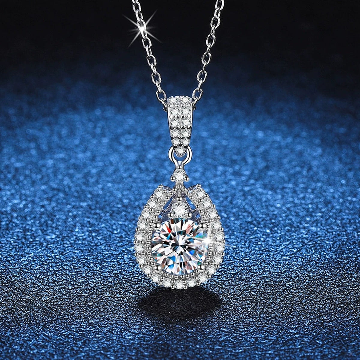 Pear Halo Moissanite Drop Necklace in Platinum-Plated S925 Sterling Silver blue background angled detail view