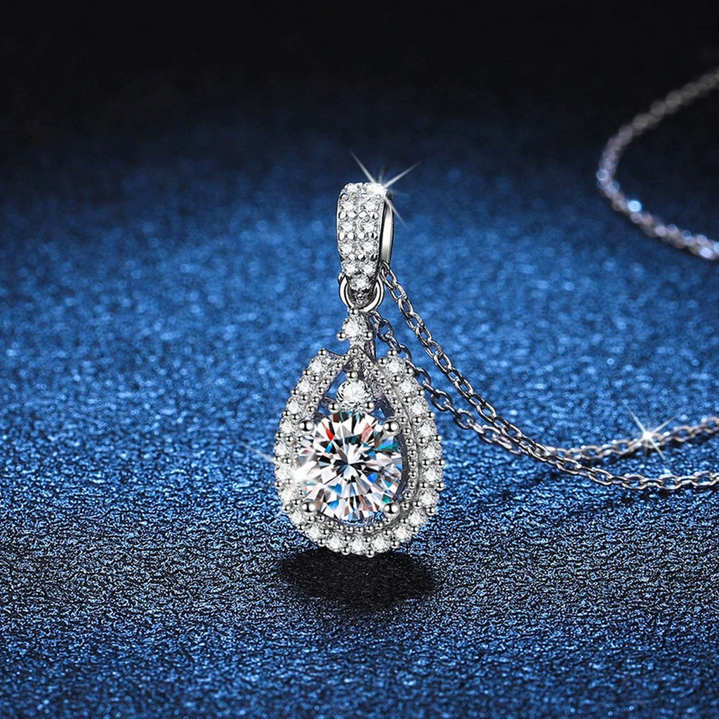 Pear Halo Moissanite Drop Necklace in Platinum-Plated S925 Sterling Silver blue background close-up view