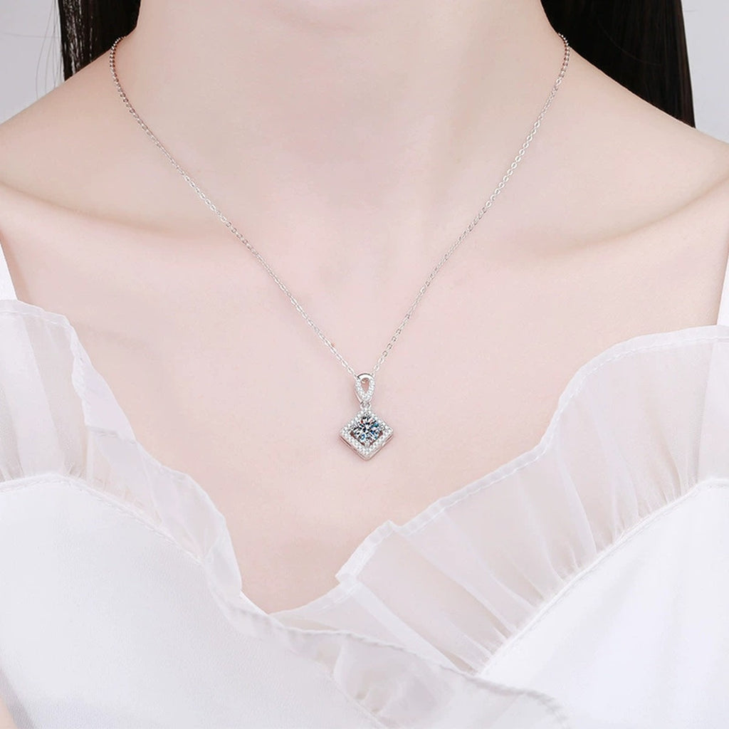 Diamond Halo Moissanite Pendant Necklace in Platinum-Plated S925 Sterling Silver worn on neckline by model