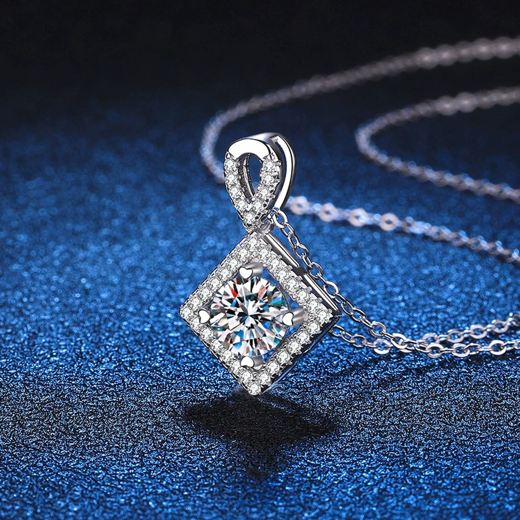 Diamond Halo Moissanite Pendant Necklace in Platinum-Plated S925 Sterling Silver blue background angled detail view