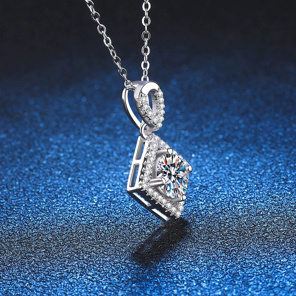 Diamond Halo Moissanite Pendant Necklace in Platinum-Plated S925 Sterling Silver blue background close-up view