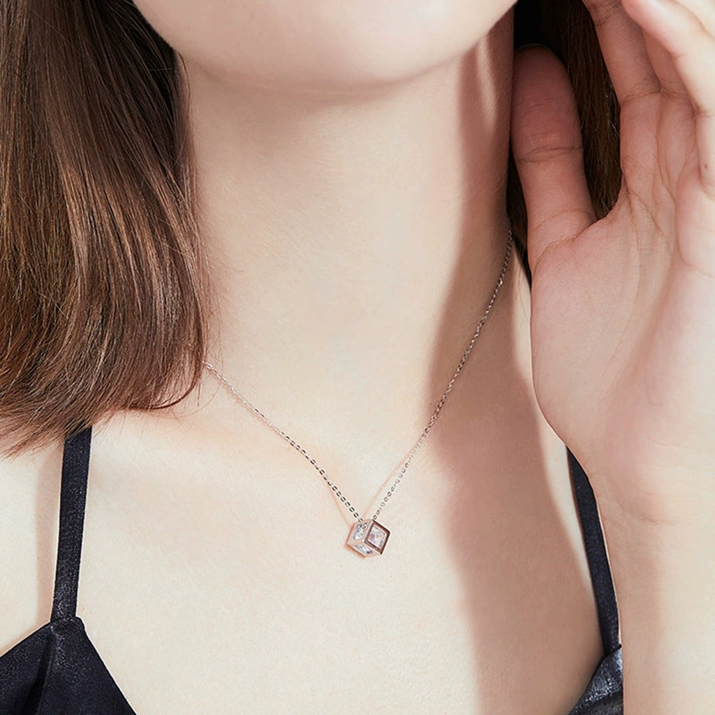 Cube Moissanite Pendant Necklace in Platinum-Plated S925 Sterling Silver worn by model at neckline