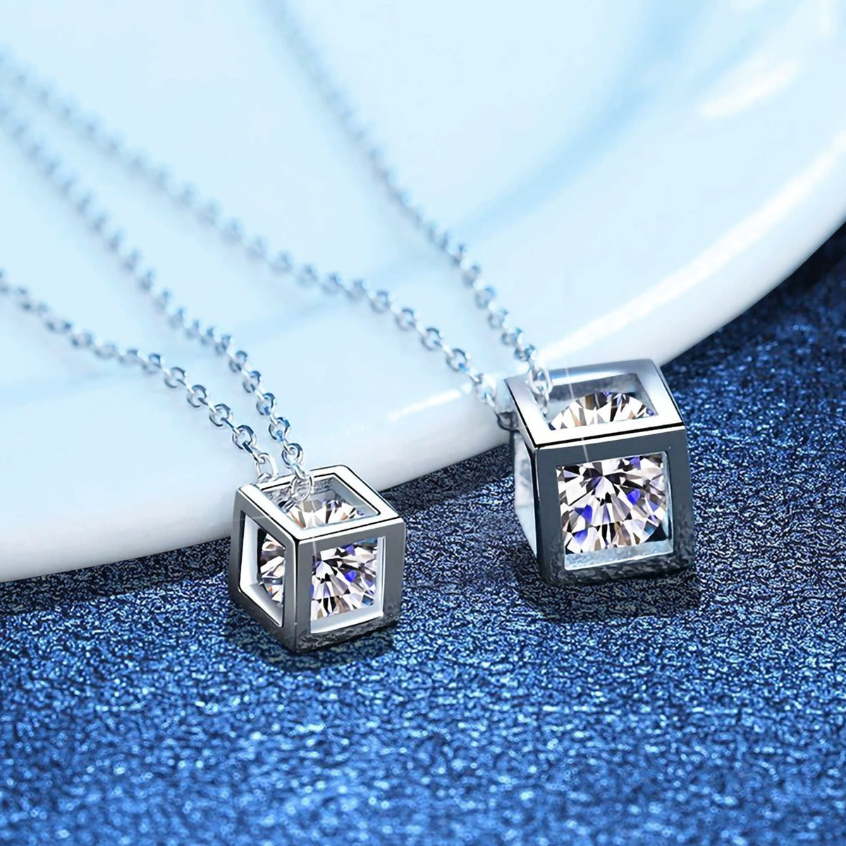 Cube Moissanite Pendant Necklace in Platinum-Plated S925 Sterling Silver blue background angled detail view