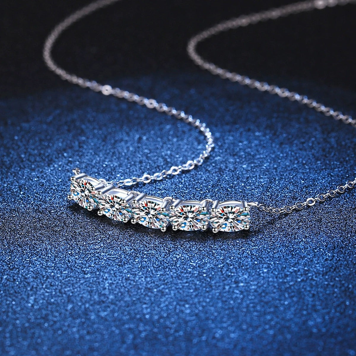 Graduated Five-Stone Moissanite Necklace in Platinum-Plated S925 Sterling Silver blue background product view