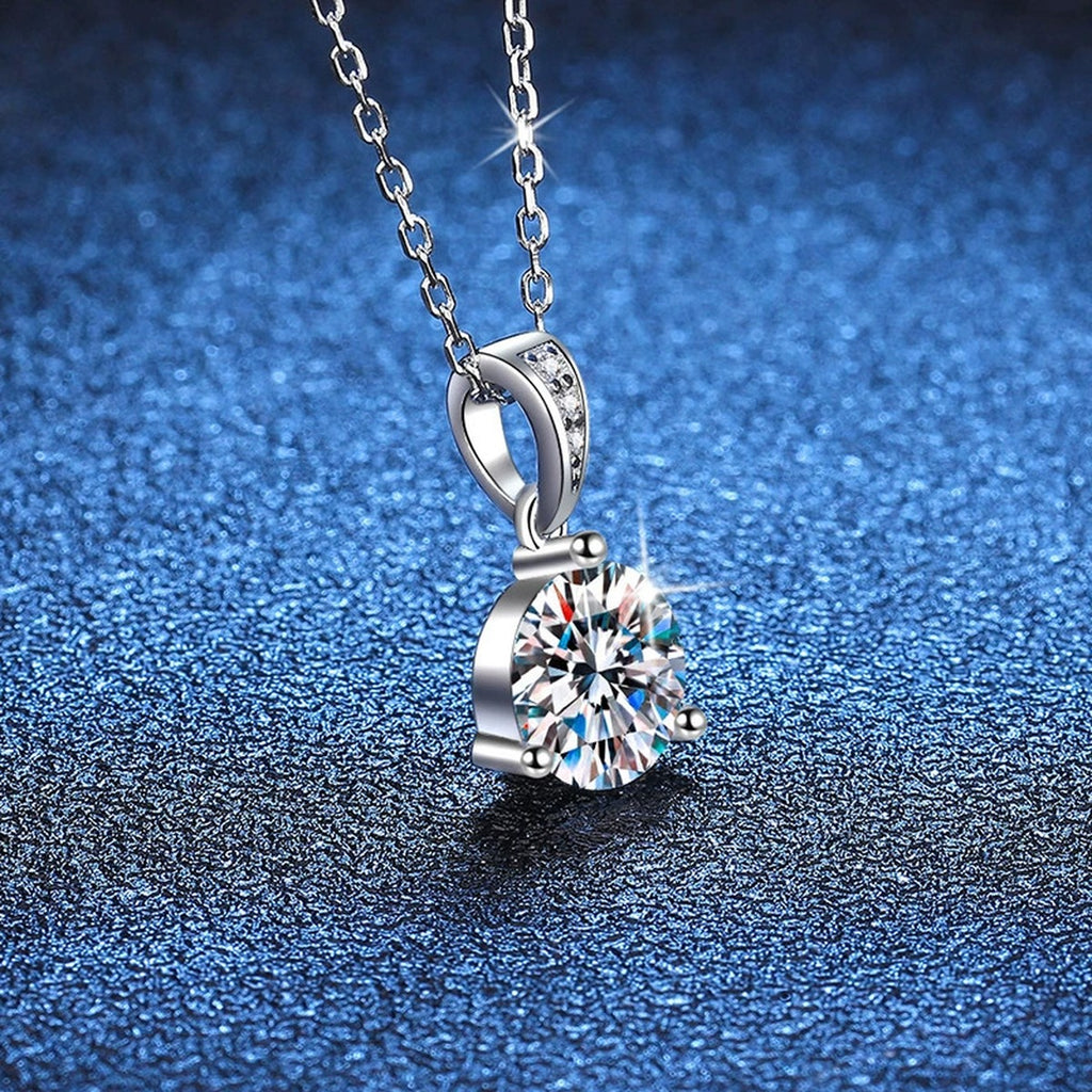 Round Moissanite Pendant Necklace in Platinum-Plated S925 Sterling Silver blue background angled detail view