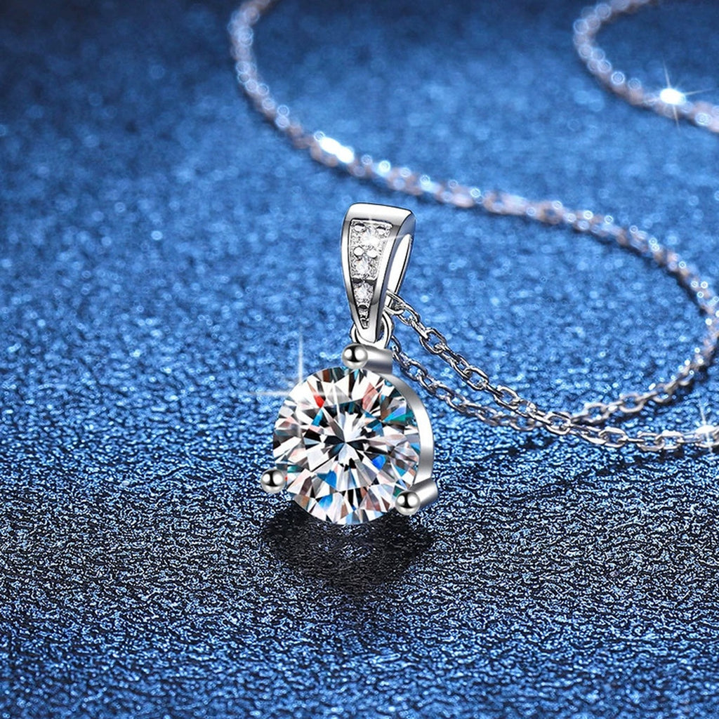 Round Moissanite Pendant Necklace in Platinum-Plated S925 Sterling Silver blue background close-up view