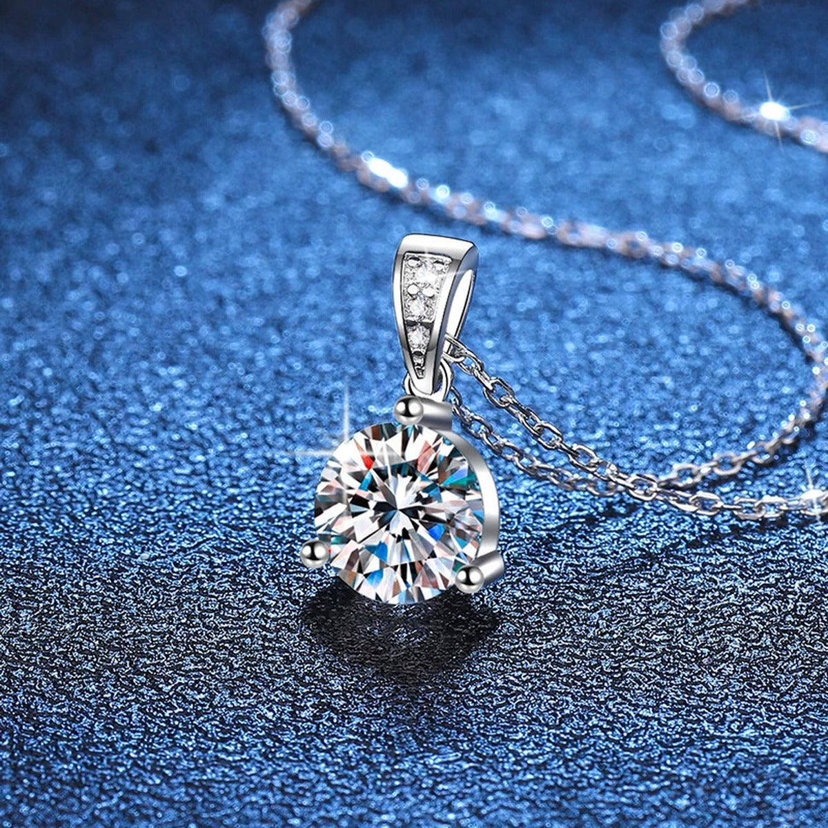 Round Moissanite Pendant Necklace in Platinum-Plated S925 Sterling Silver blue background close-up view