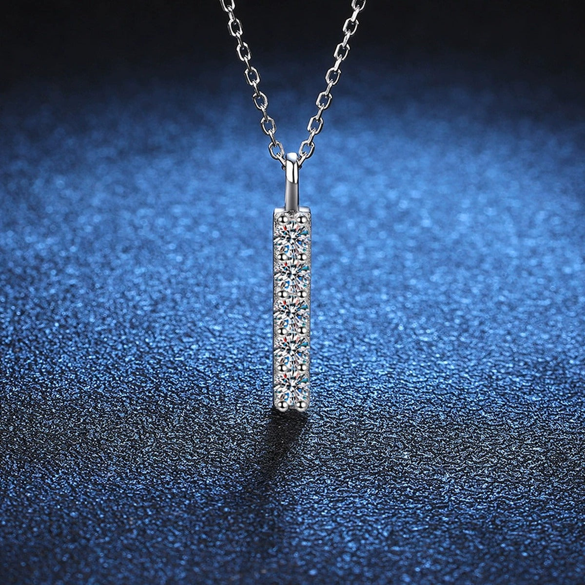 Vertical Bar Moissanite Pendant Necklace in Platinum-Plated S925 Sterling Silver blue background close-up view