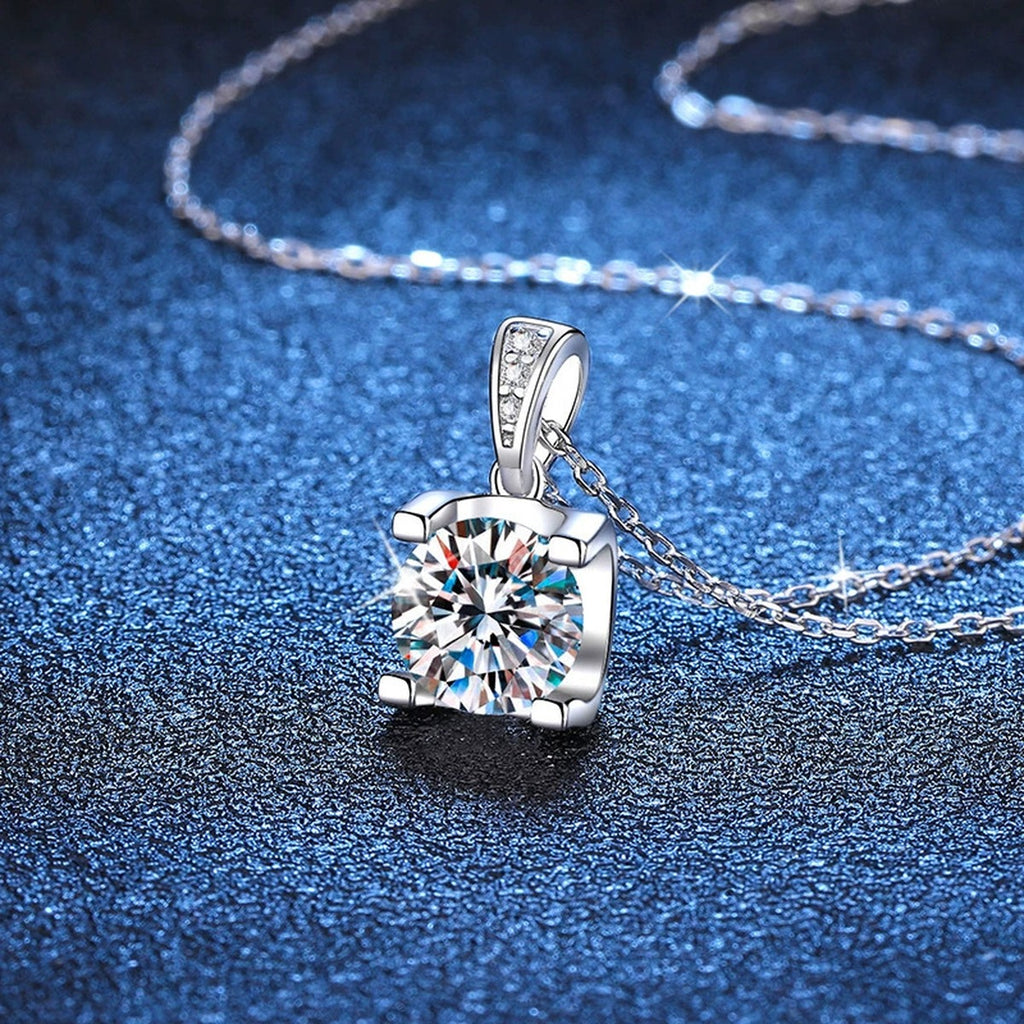 Basket-Set Round Moissanite Pendant Necklace in Platinum-Plated S925 Sterling Silver blue background angled detail view
