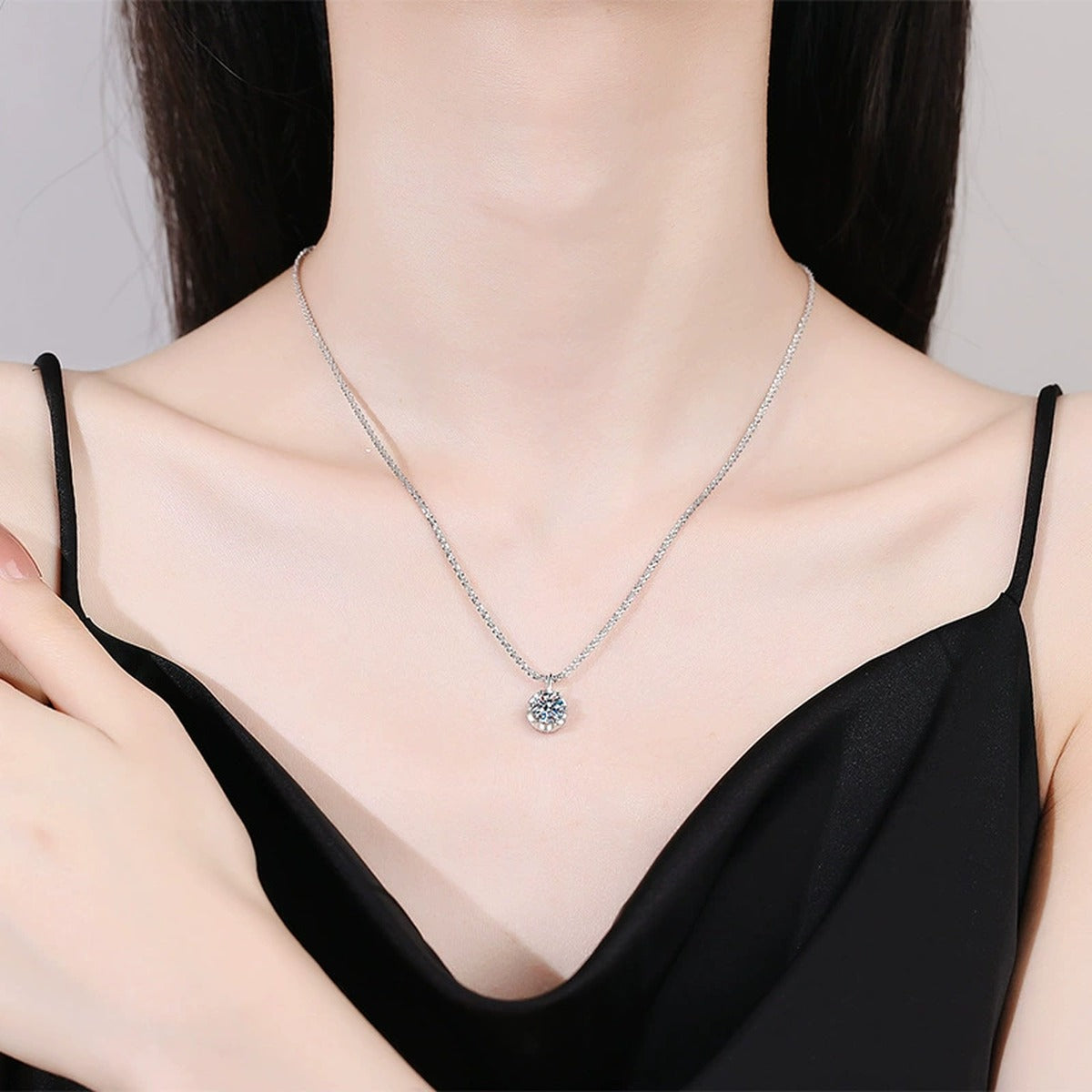 Round Bezel Halo Moissanite Pendant Necklace in Platinum-Plated S925 Sterling Silver worn on neckline by model