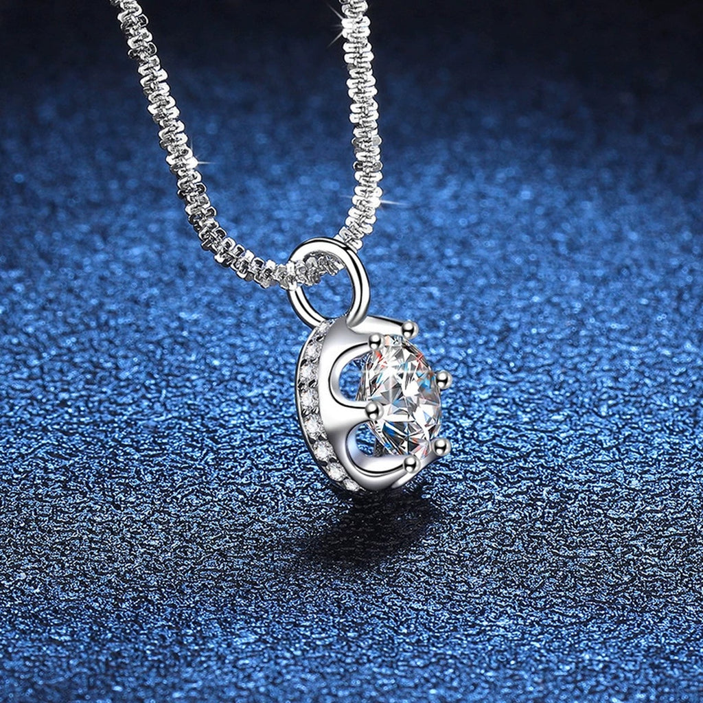 Round Bezel Halo Moissanite Pendant Necklace in Platinum-Plated S925 Sterling Silver blue background angled detail view