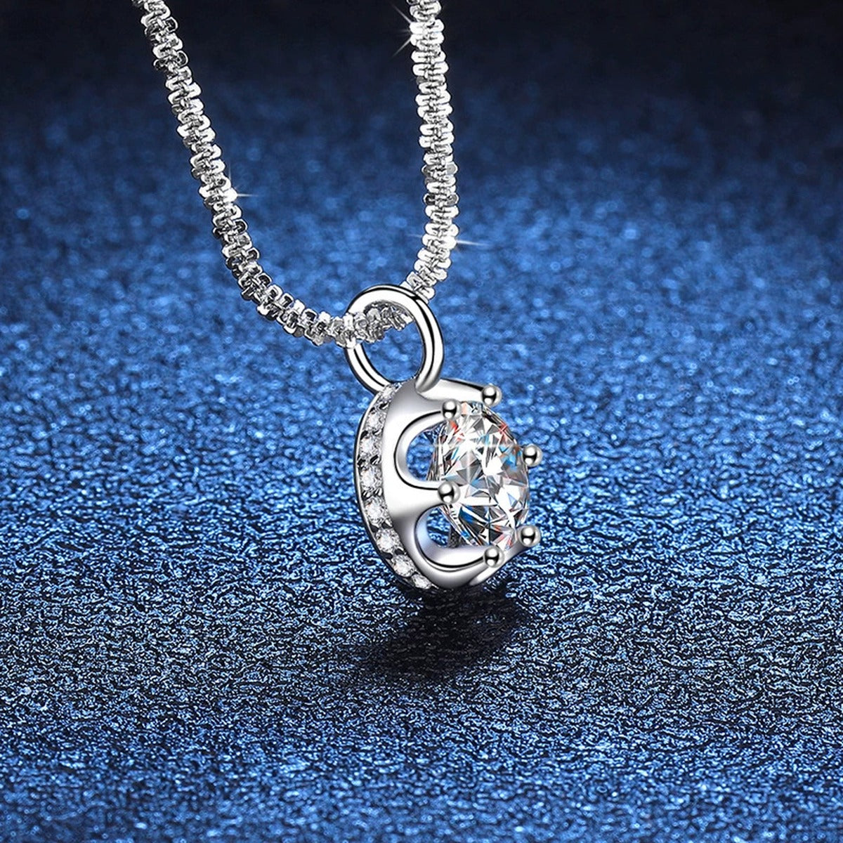 Round Bezel Halo Moissanite Pendant Necklace in Platinum-Plated S925 Sterling Silver blue background angled detail view