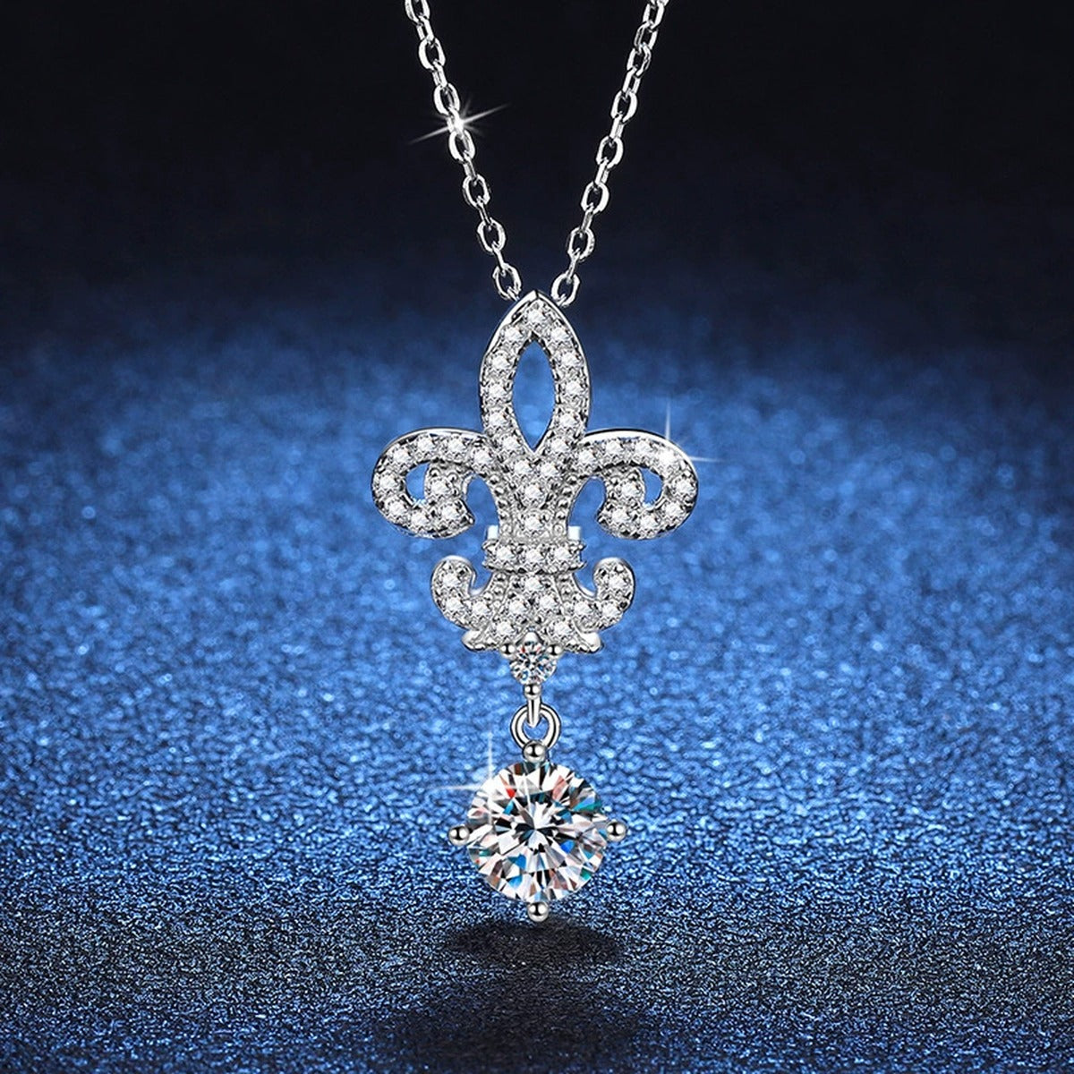Fleur-De-Lis Moissanite Drop Necklace in Platinum-Plated S925 Sterling Silver blue background angled detail view