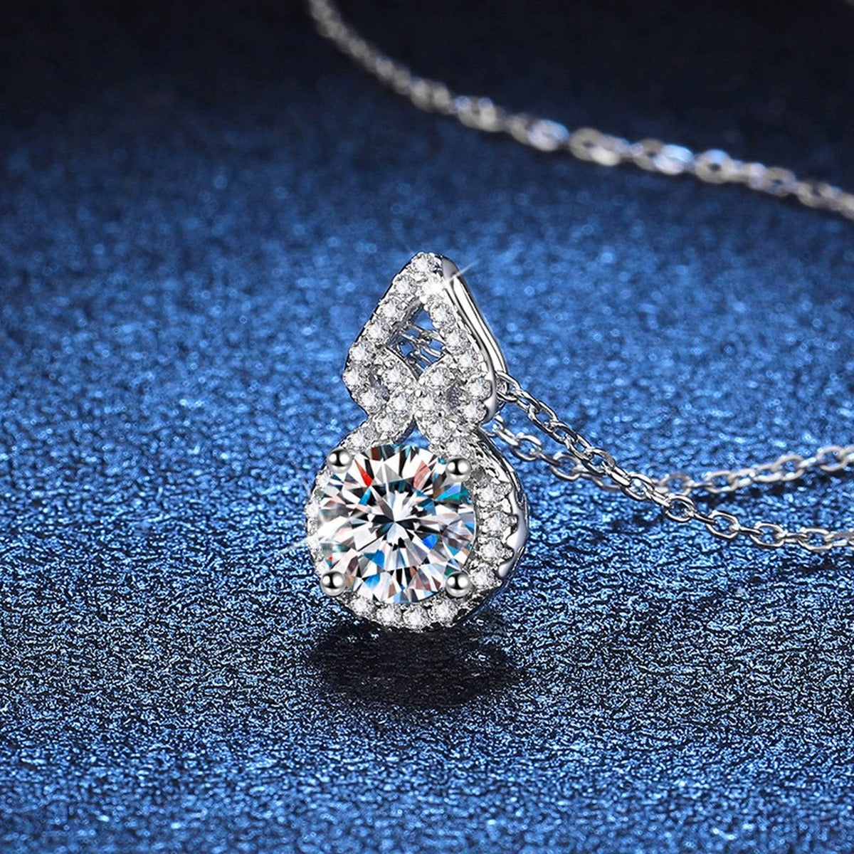 Pear Halo Moissanite Drop Necklace in Platinum-Plated S925 Sterling Silver blue background close-up view