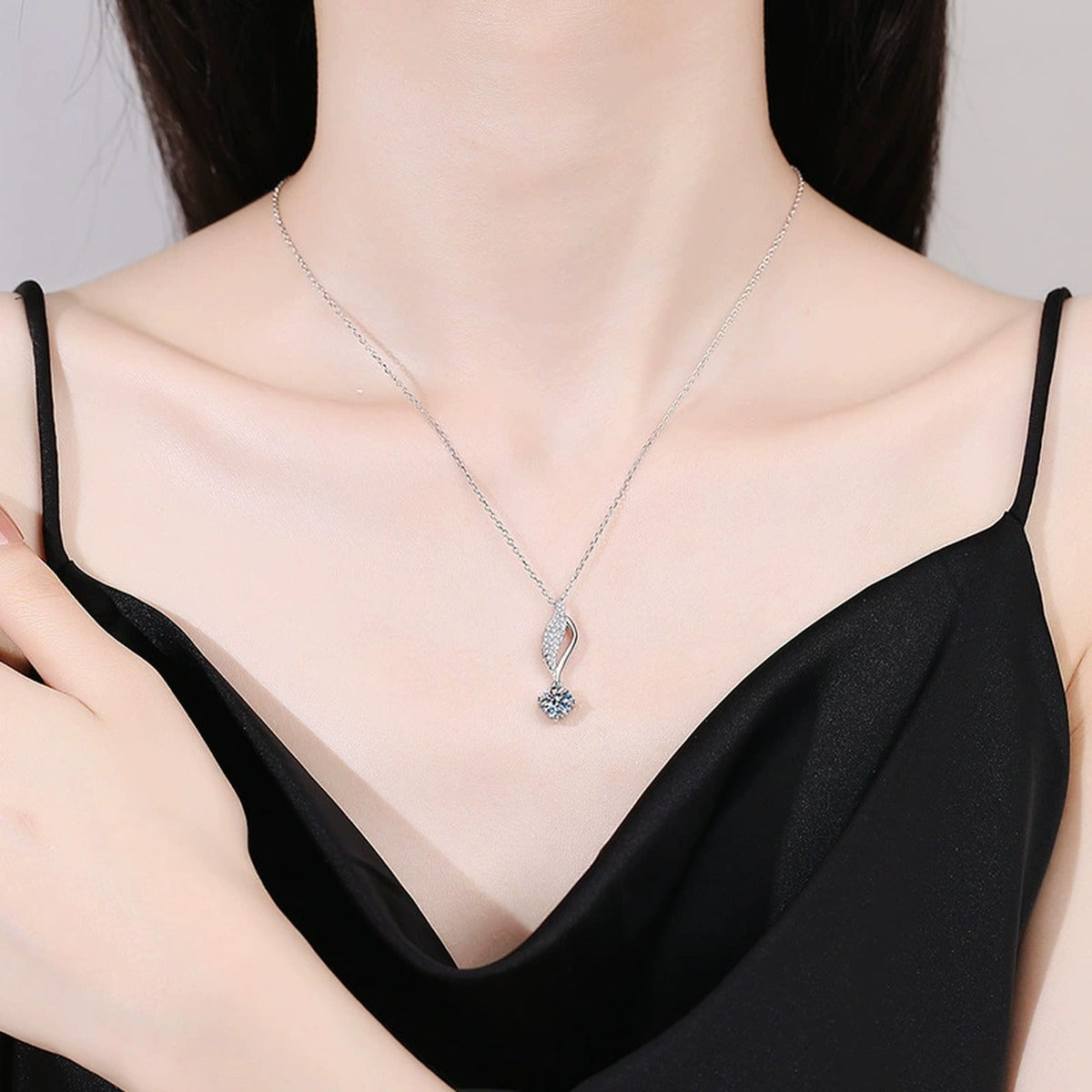 Curved Leaf Moissanite Drop Necklace in Platinum-Plated S925 Sterling Silver worn on neckline by model