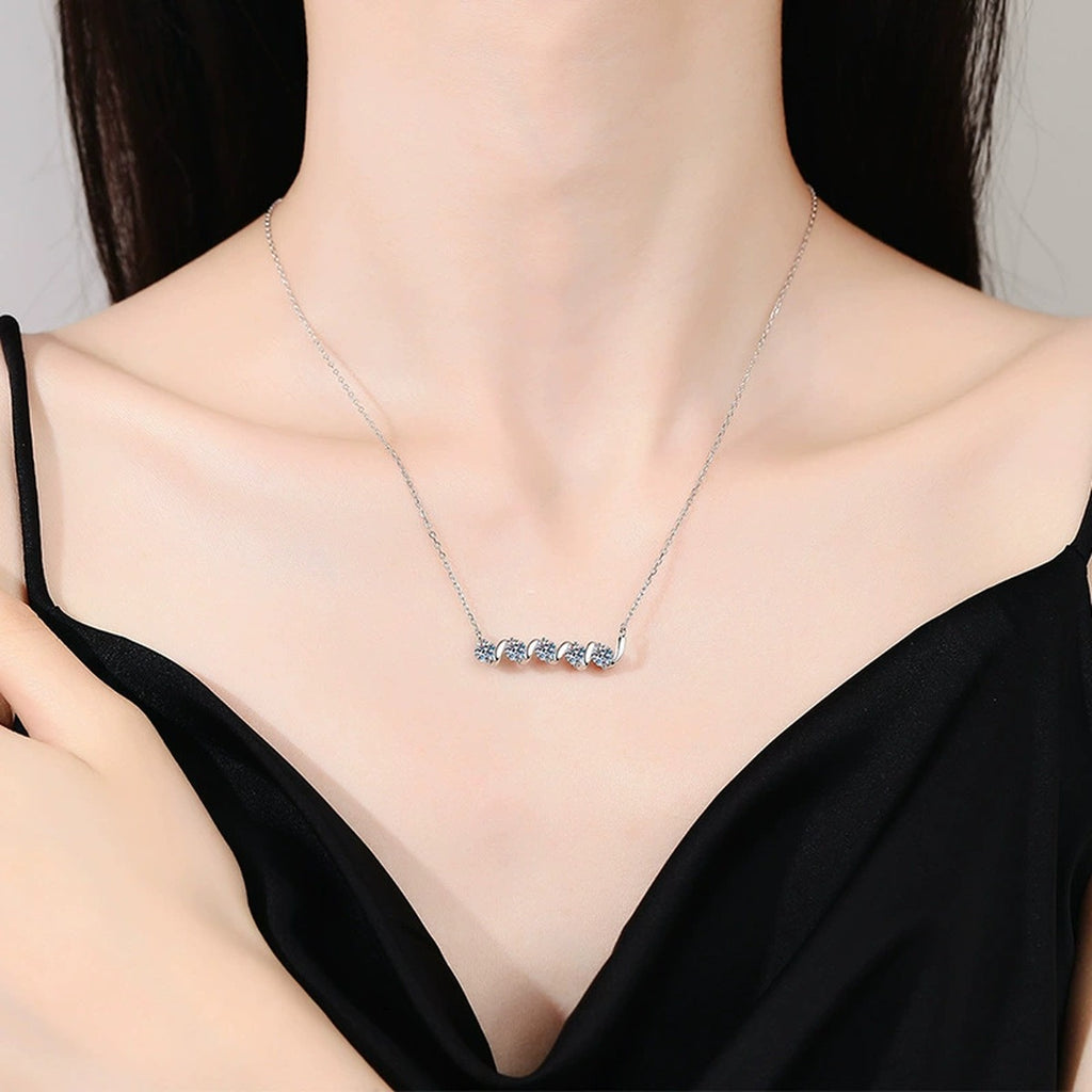Graduated Five-Stone Moissanite Station Necklace in Platinum-Plated S925 Sterling Silver worn on neckline by model