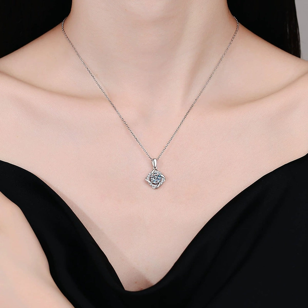 Round Quatrefoil Halo Moissanite Pendant Necklace in Platinum-Plated S925 Sterling Silver worn on neckline by model
