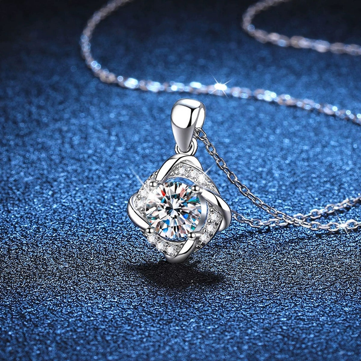 Round Quatrefoil Halo Moissanite Pendant Necklace in Platinum-Plated S925 Sterling Silver blue background angled detail view