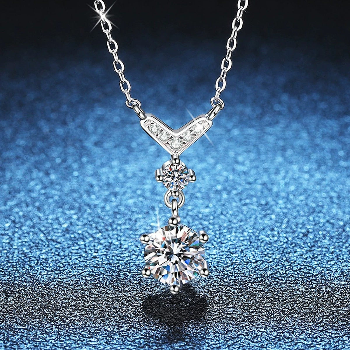 Chevron Drop Moissanite Necklace in Platinum-Plated S925 Sterling Silver blue background close-up view