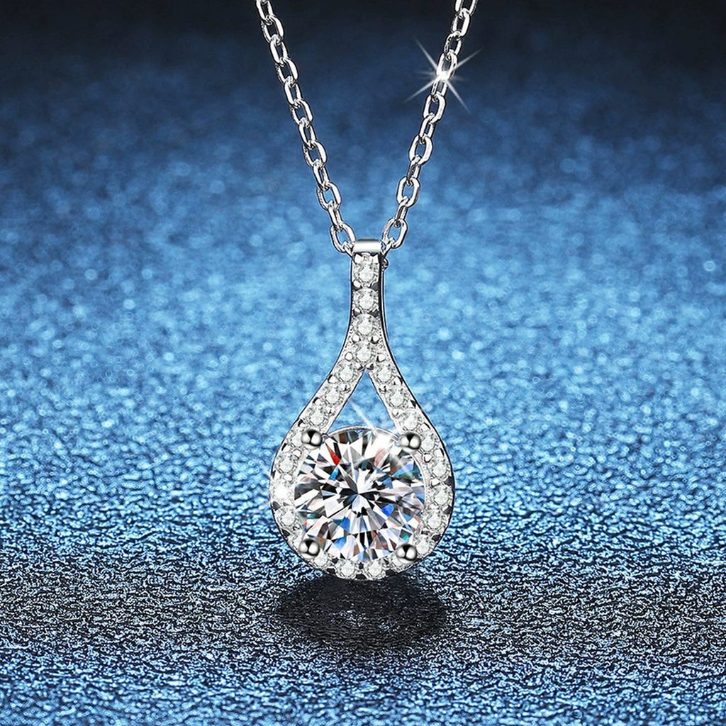 Pear Halo Moissanite Pendant Necklace in Platinum-Plated S925 Sterling Silver blue background close-up view
