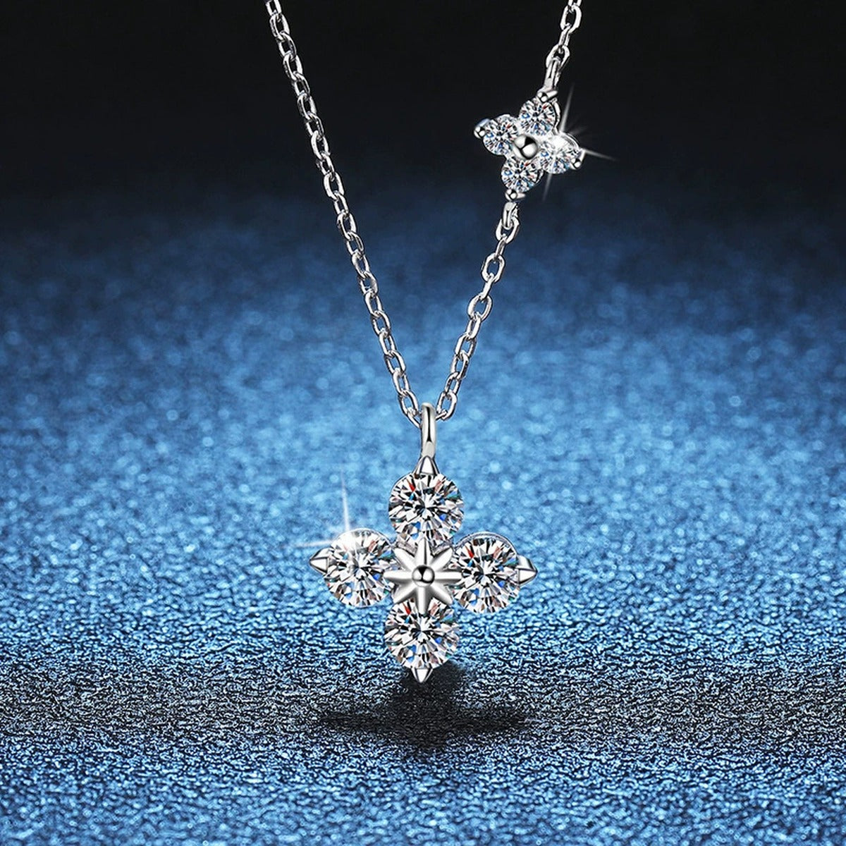 Four-Stone Clover Moissanite Pendant Necklace in S925 Sterling Silver blue background angled detail view