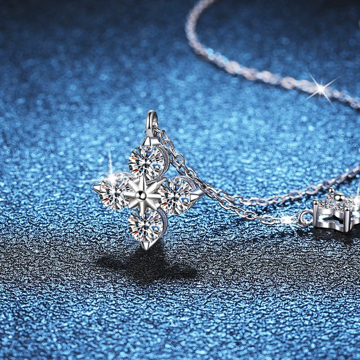 Four-Stone Clover Moissanite Pendant Necklace in S925 Sterling Silver blue background styling view