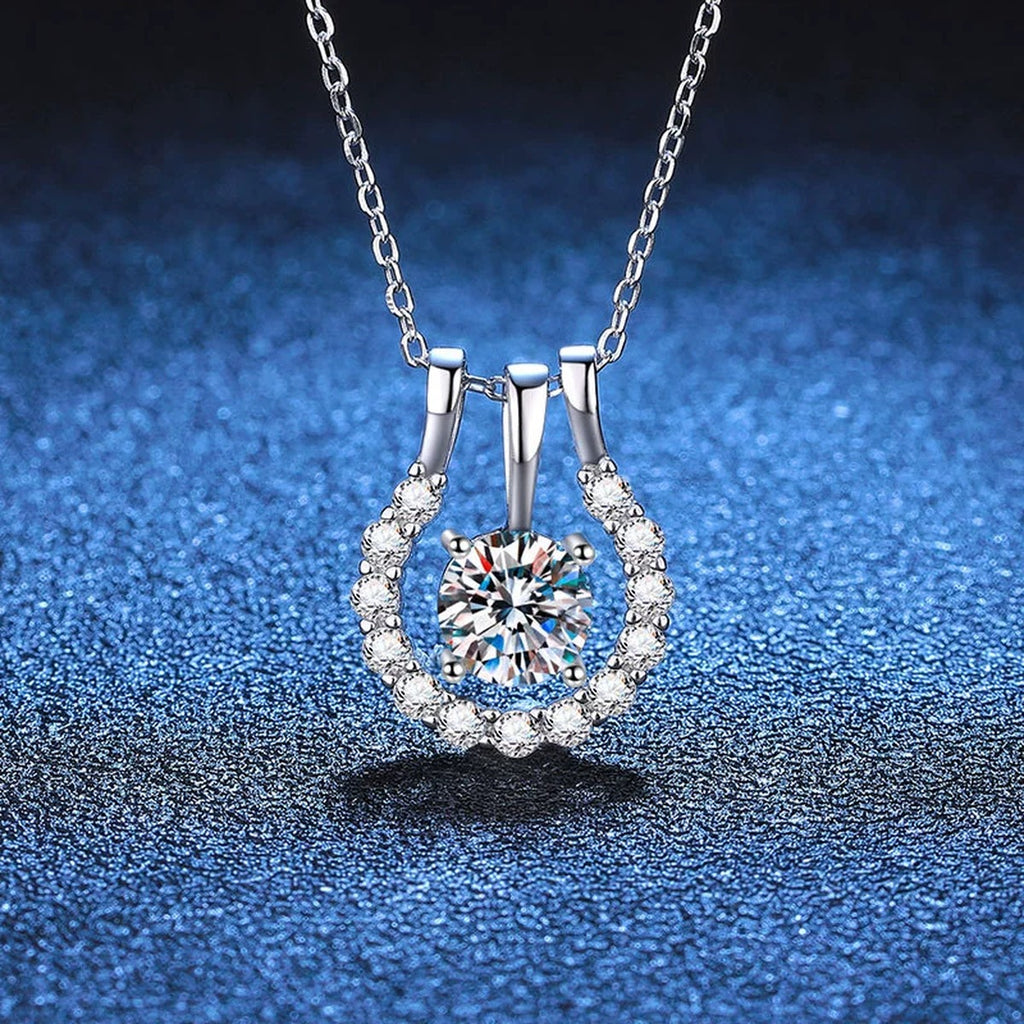 Horseshoe Halo Moissanite Pendant Necklace in Platinum-Plated S925 Sterling Silver blue background angled detail view