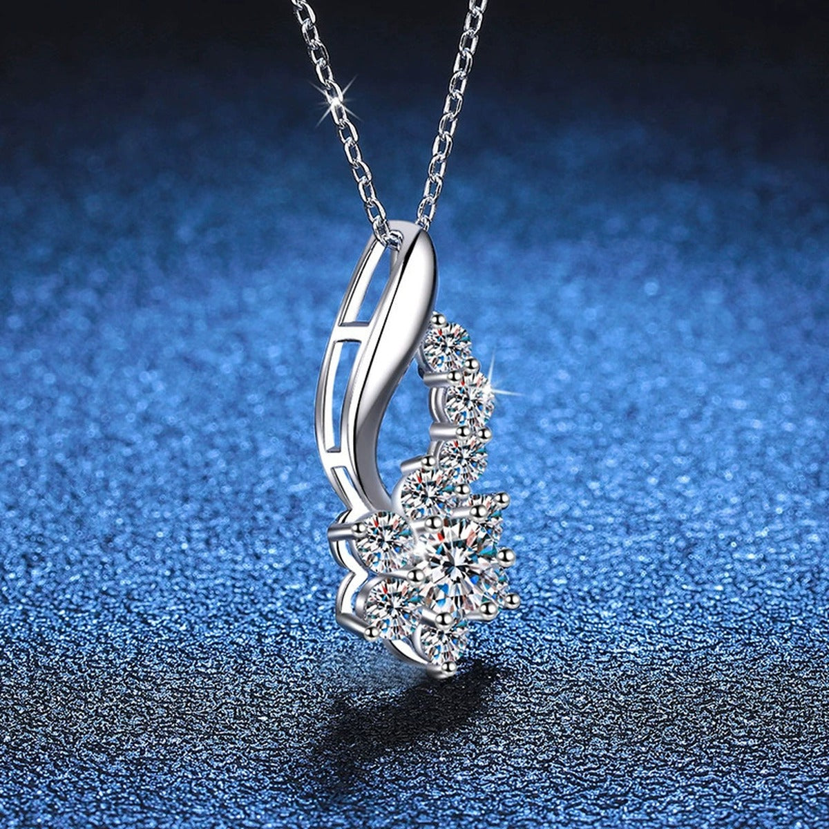 Starburst Moissanite Drop Necklace in Platinum-Plated S925 Sterling Silver blue background close-up view