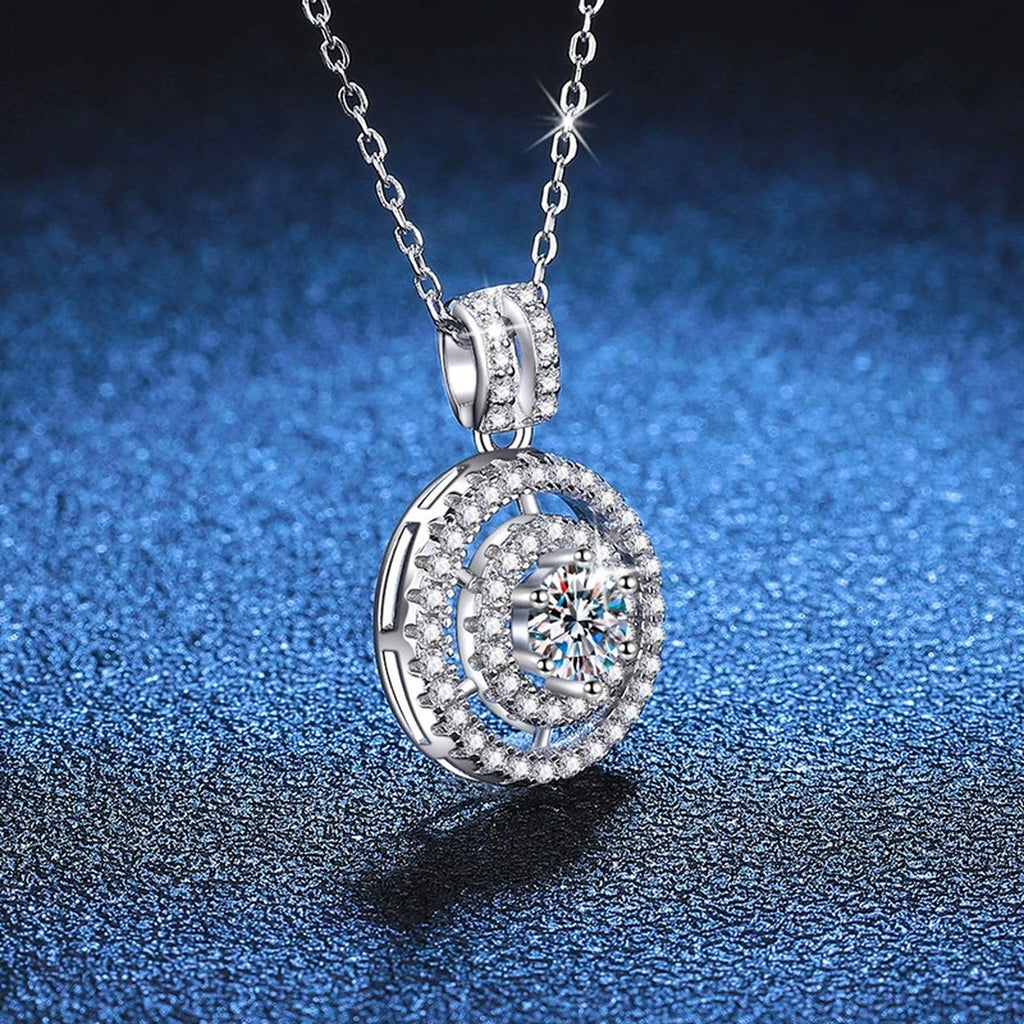 Concentric Halo Moissanite Pendant Necklace in Platinum-Plated S925 Sterling Silver blue background angled detail view