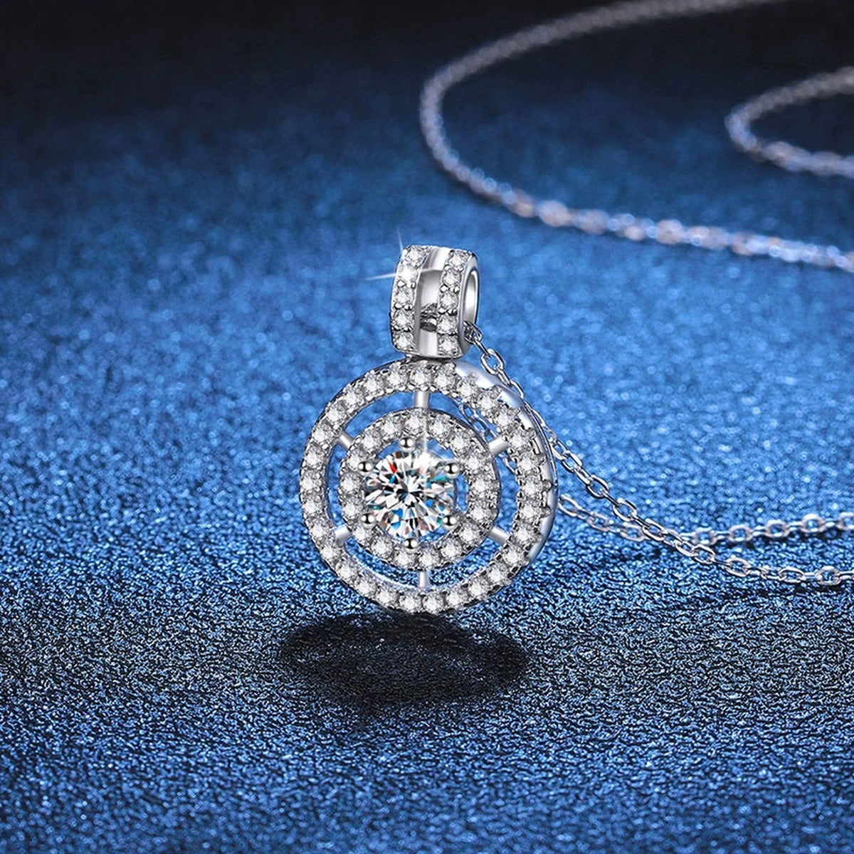 Concentric Halo Moissanite Pendant Necklace in Platinum-Plated S925 Sterling Silver blue background close-up view