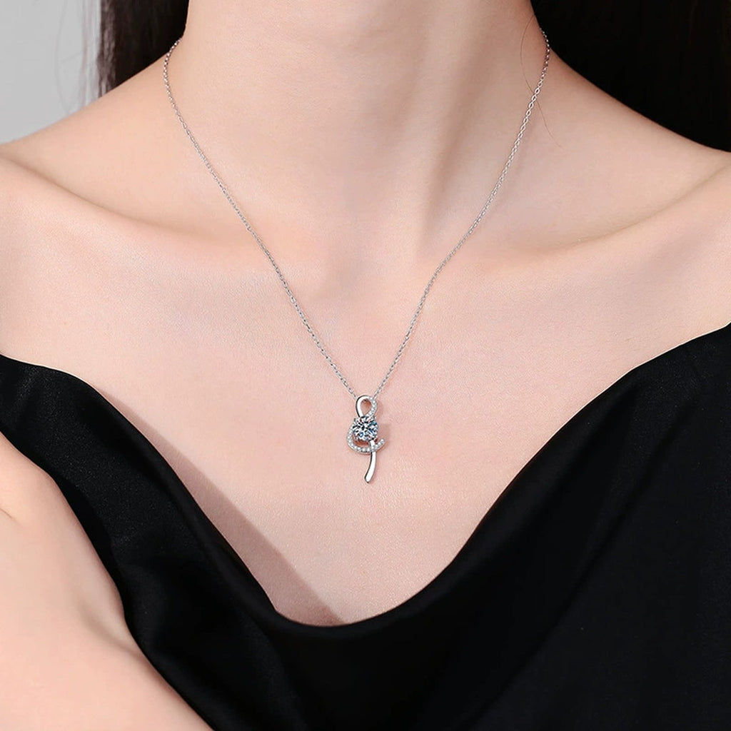 Crescent Moissanite Pendant Necklace in Platinum-Plated S925 Sterling Silver worn on neckline by model