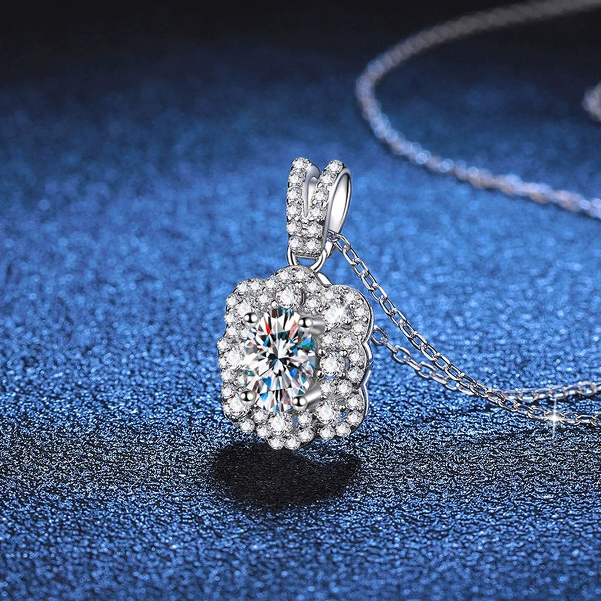 Cushion Halo Pear Moissanite Pendant Necklace in Platinum-Plated S925 Sterling Silver blue background angled detail view
