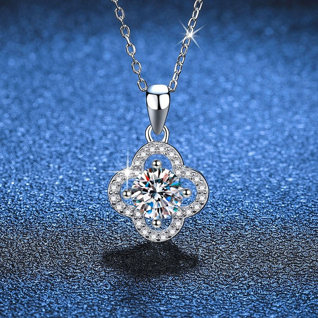Four-Leaf Clover Halo Moissanite Pendant Necklace in Platinum-Plated S925 Sterling Silver blue background angled view
