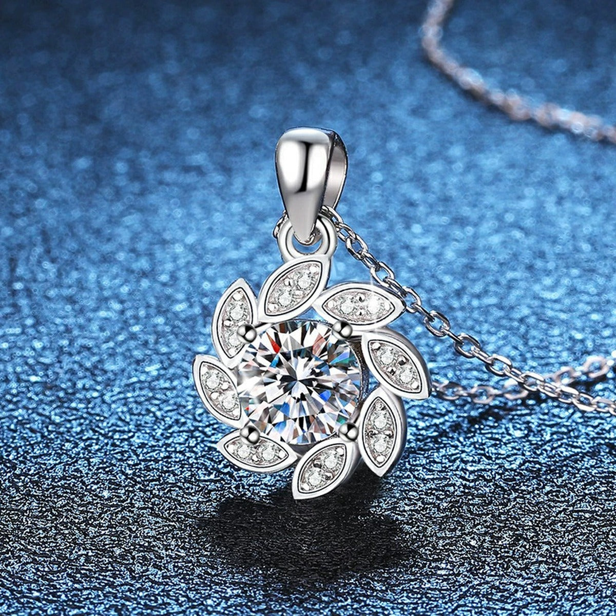 Floral Swirl Moissanite Pendant Necklace in Platinum-Plated S925 Sterling Silver blue background angled view