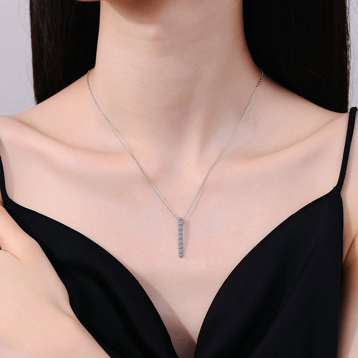Slim Bar Moissanite Drop Necklace in Platinum-Plated S925 Sterling Silver worn on neckline by model