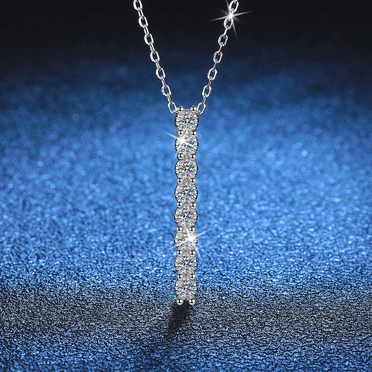 Slim Bar Moissanite Drop Necklace in Platinum-Plated S925 Sterling Silver blue background angled view
