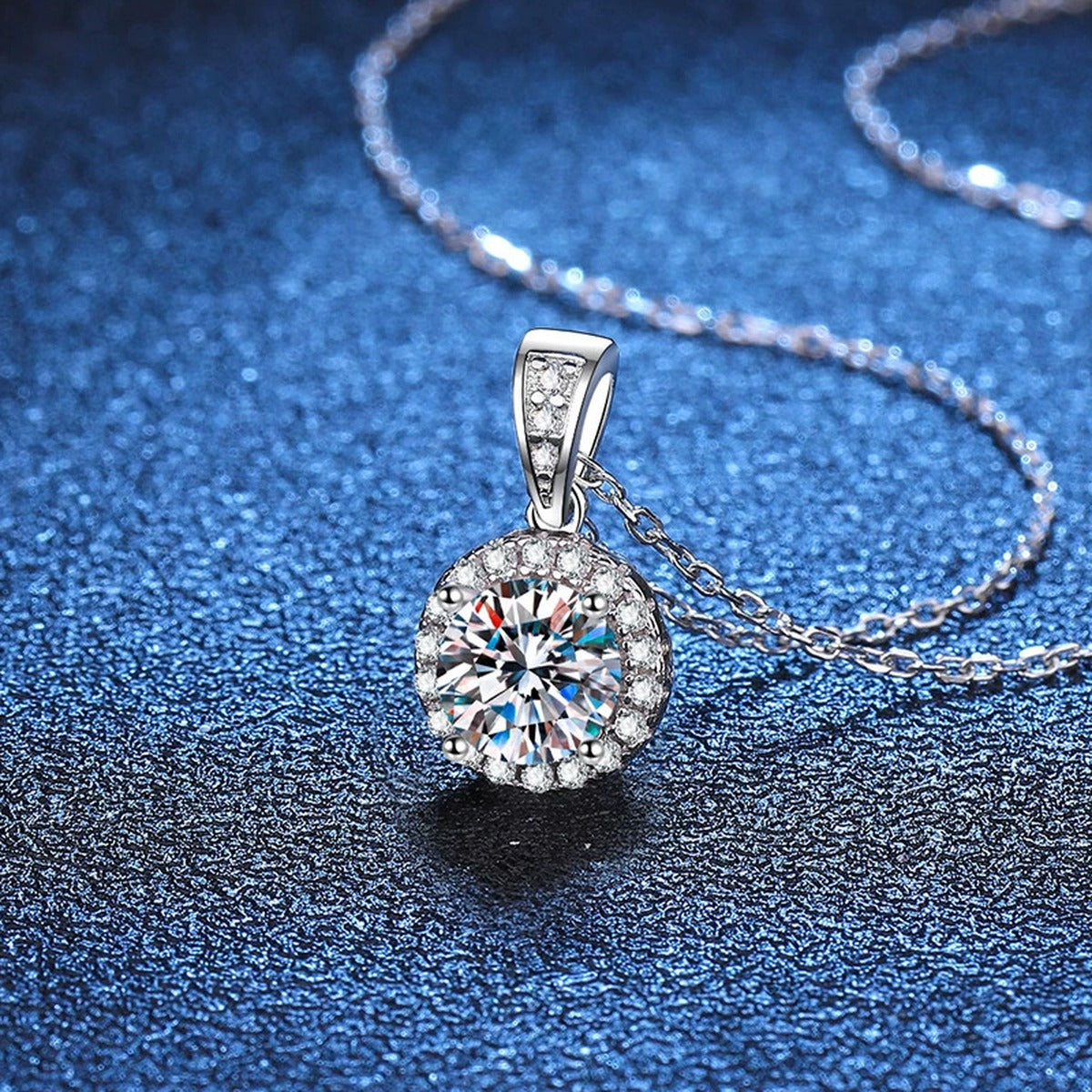 Round Halo Moissanite Pendant Necklace in Platinum-Plated S925 Sterling Silver blue background angled view