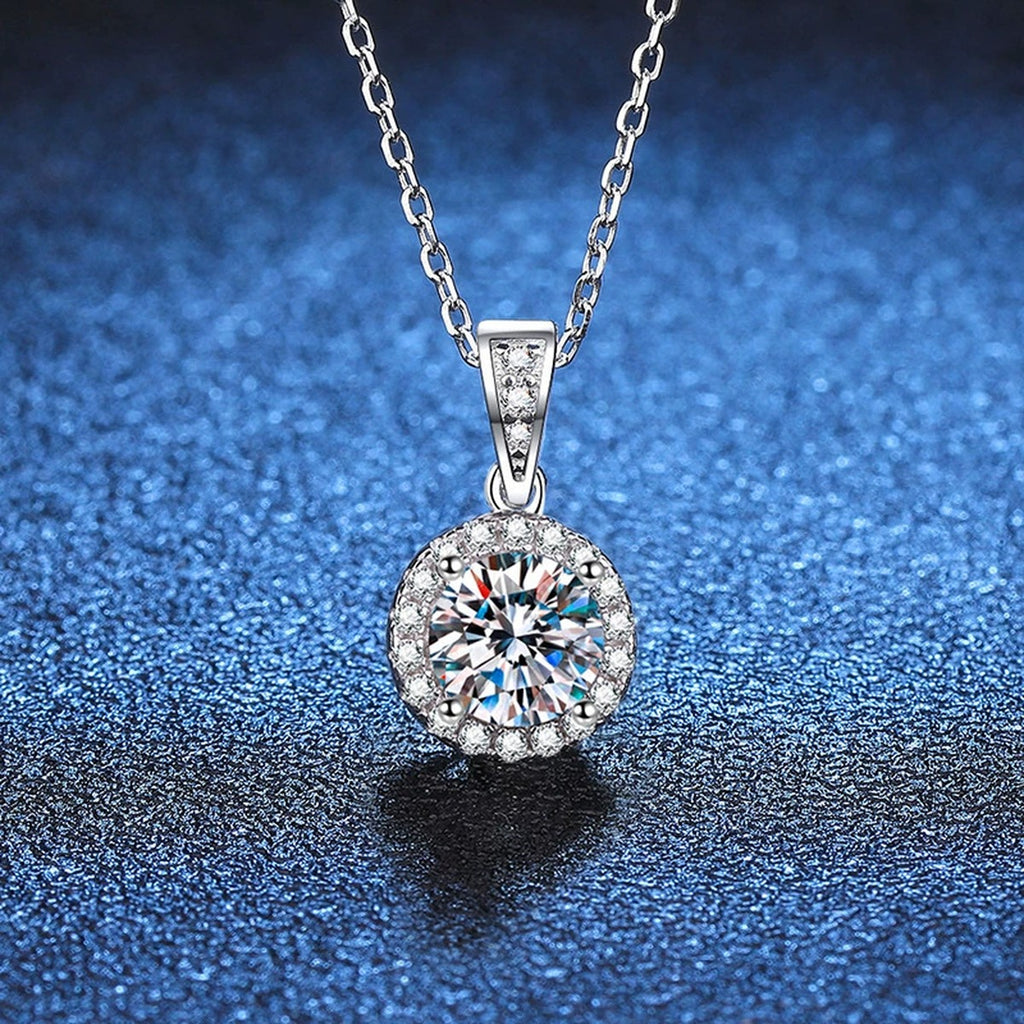Round Halo Moissanite Pendant Necklace in Platinum-Plated S925 Sterling Silver blue background close-up view