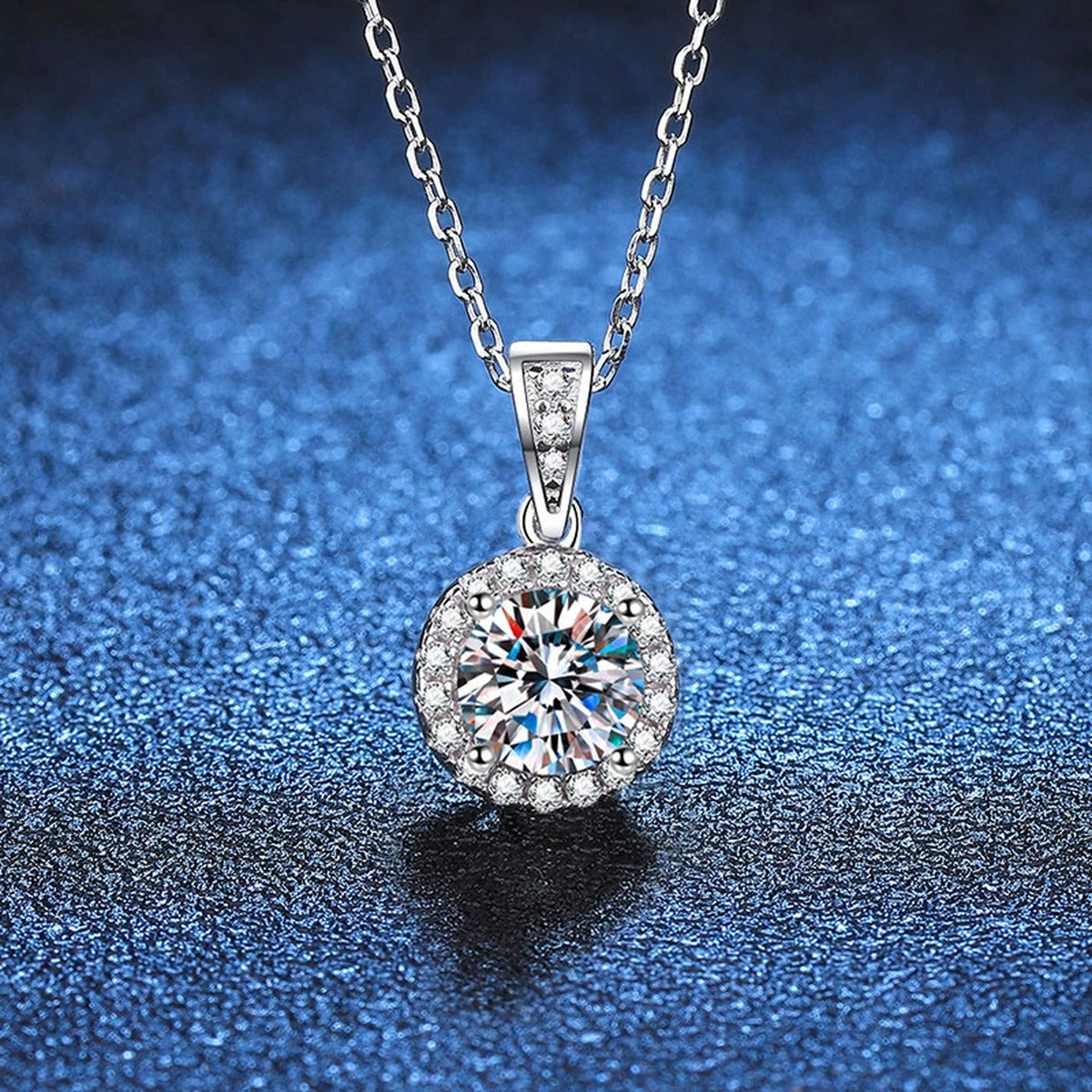 Round Halo Moissanite Pendant Necklace in Platinum-Plated S925 Sterling Silver blue background close-up view