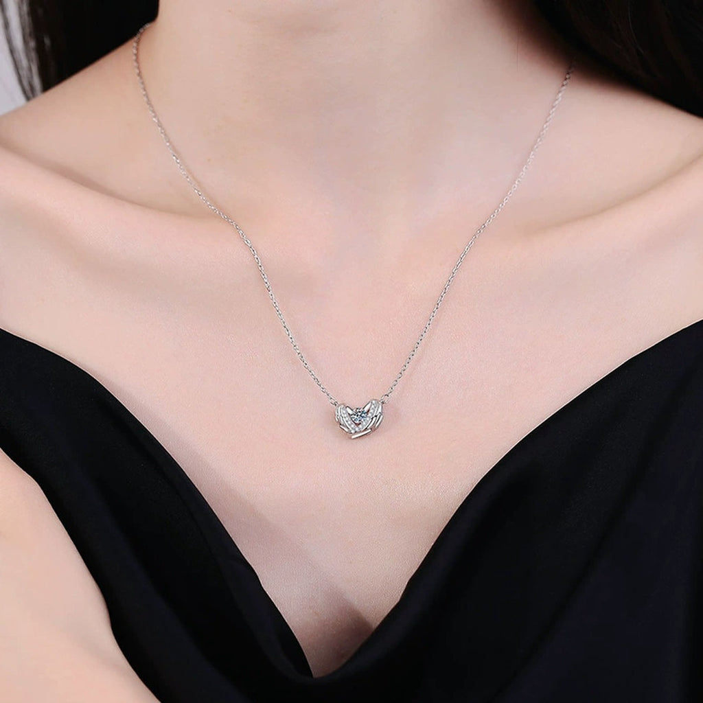 Ribbon Heart Moissanite Pendant Necklace in Platinum-Plated S925 Sterling Silver worn on neckline by model