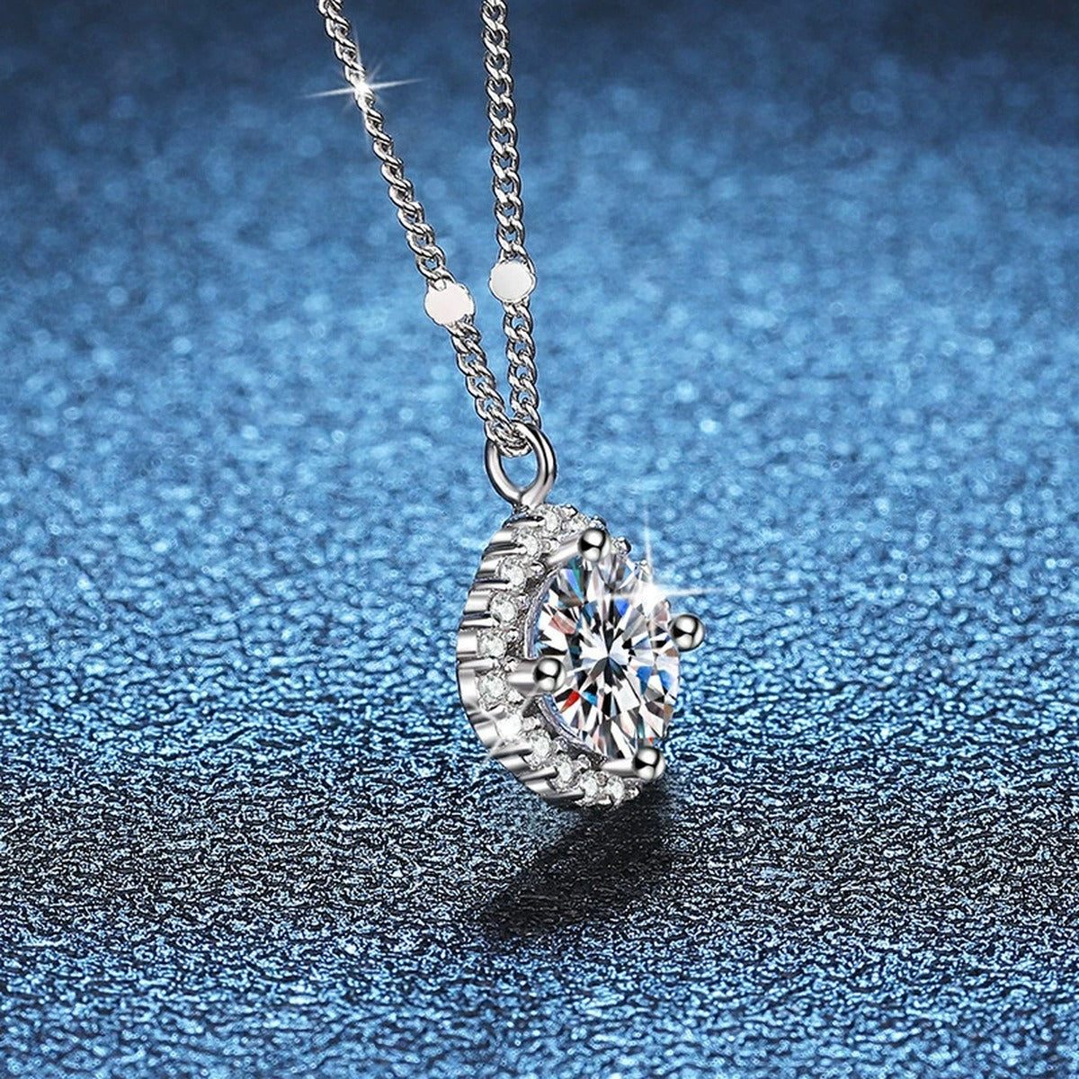 Cushion Halo Moissanite Pendant Necklace in Platinum-Plated S925 Sterling Silver blue background angled view